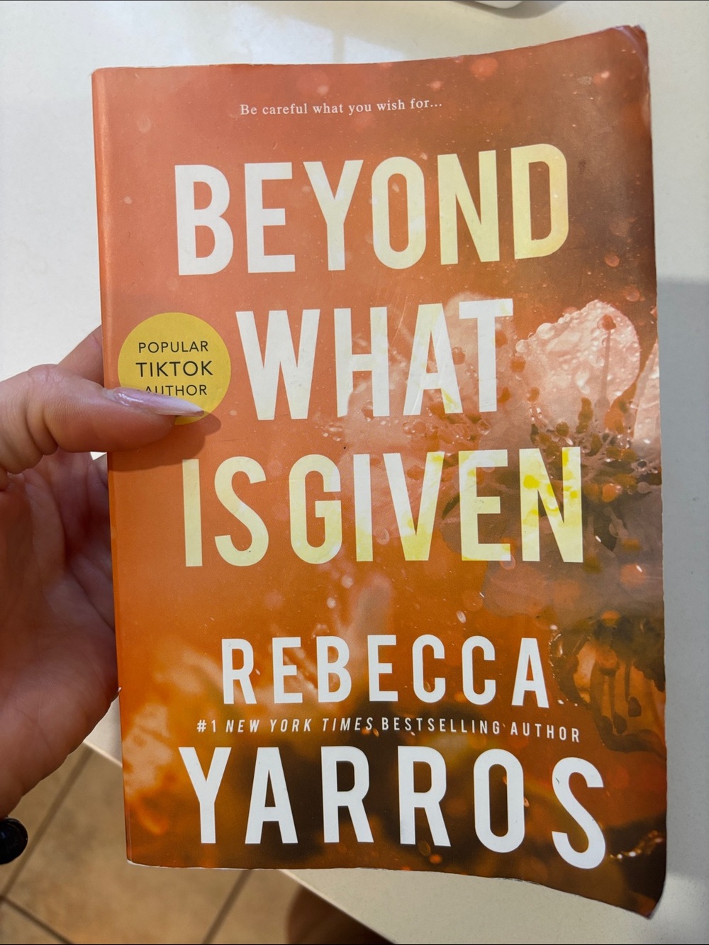Beyond What Is Given by Rebecca Yarros - Orange paperback